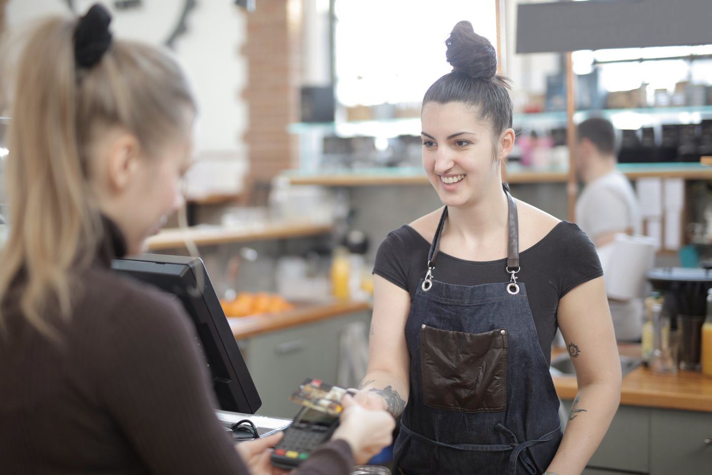A customer paying by card at the counter