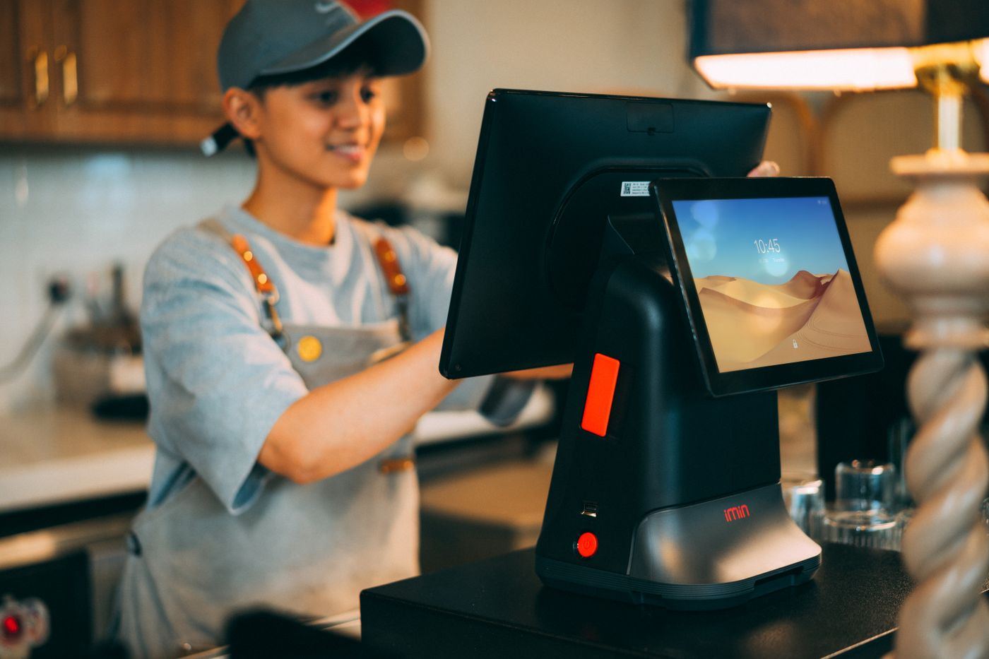 A cashier working at a counter terminal