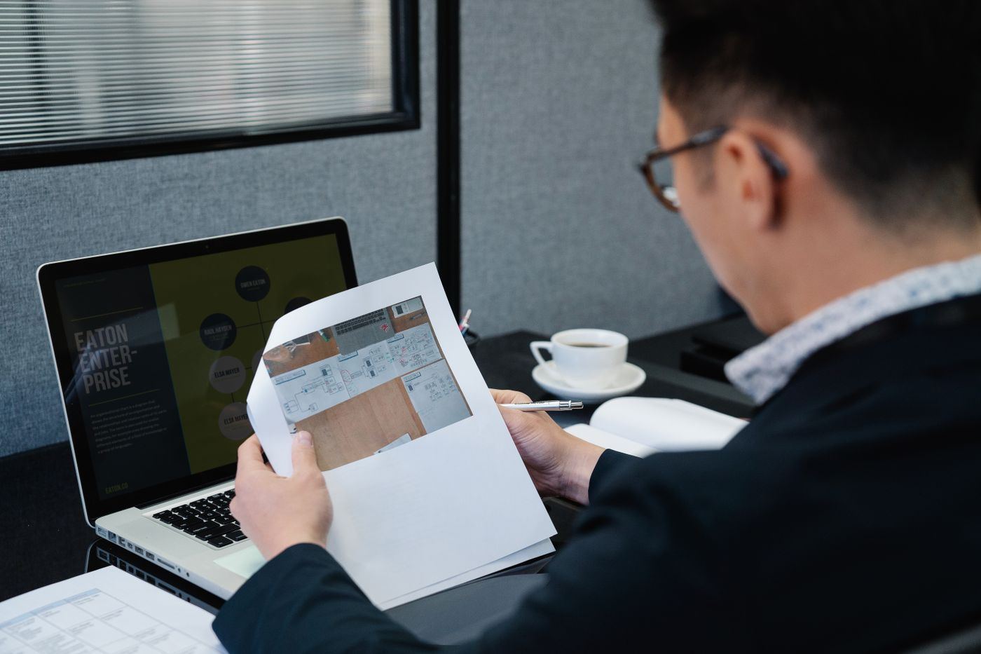 A finance officer with documents and a laptop