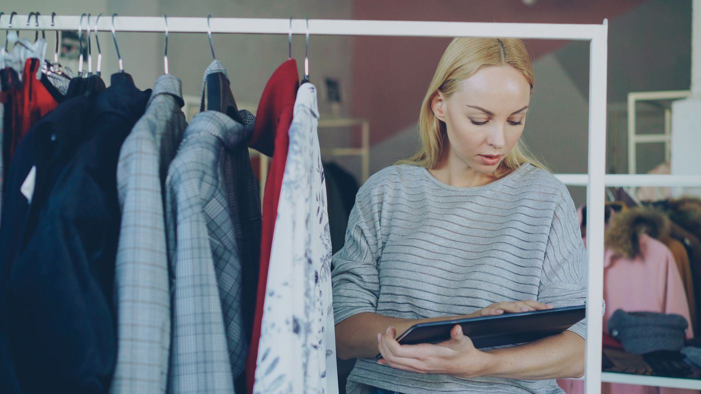 An outlet manager checking stock on a tablet