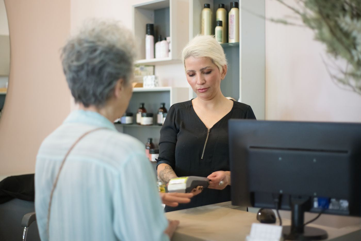 A cashier serving a customer at a pharmacy counter
